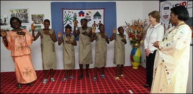 Mrs. Laura Bush and Madame Chantal de Souza Yayi, wife of President Boni Yayi, enjoy a performance by recipients of the Ambassador's Girls Scholarship during a visit Saturday, Feb. 16, 2008, by President George W. Bush and Mrs. Bush to Benin.