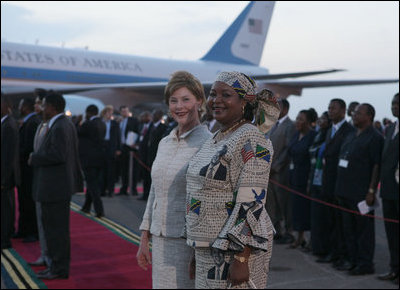 Mrs. Laura Bush and Salma Kikwete, wife of President Jakaya Kikwete of Tanzania, stand on the red carpet Saturday, Feb. 16, 2008, after the arrival of President George W. Bush and Mrs. Bush to Julius Nyerere International Airport in Dar es Salaam.