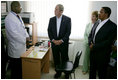 President George W. Bush and Mrs. Laura Bush, joined by Tanzanian President Jakaya Kikwete, visit with a staff doctor Sunday, Feb. 17, 2008, at the Amana District Hospital in Dar es Salaam, Tanzania, where President Bush and Mrs. Bush visited a patients and staff at the hospital's care and treament clinic.