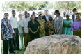 President George W. Bush and Mrs. Laura Bush, joined by U.S. Secretary of State Condoleezza Rice, stand with the family members of victims during a moment of silence Sunday, Feb. 17, 2008 in the memorial garden of the U.S. embassy in Dar es Salaam in Tanzania, in remembrance for those who died in the 1998 U.S. embassy bombing.