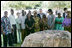 President George W. Bush and Mrs. Laura Bush, joined by U.S. Secretary of State Condoleezza Rice, stand with the family members of victims during a moment of silence Sunday, Feb. 17, 2008 in the memorial garden of the U.S. embassy in Dar es Salaam in Tanzania, in remembrance for those who died in the 1998 U.S. embassy bombing.