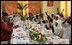 Mrs. Laura Bush and Mrs. Salma Kikwete sit at the head of the table during a roundtable Sunday, Feb. 17, 2008, in Dar es Salaam, with Madrasa graduates who have received HIV prevention education as part of their religious instruction. Madrasa training is comparable to the training students in the U.S. receive in Sunday school or Hebrew school.