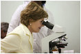 Mrs. Laura Bush views a medical slide thru a microscope Monday, Feb. 18, 2008, during a tour of the Meru District Hospital outpatient clinic in Arusha, Tanzania.