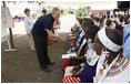 President George W. Bush, joined by Mrs. Laura Bush, greets guests, students and their families during a welcome program Monday, Feb. 18, 2008, to the Maasai Girls School in Arusha, Tanzania.