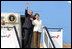 President George W. Bush and Mrs. Laura Bush wave from the steps of Air Force One Feb. 19, 2008, as they depart from Julius Nyerere International Airport in Dar es Salaam, Tanzania. The President and Mrs. Bush are on their way to Rwanda, the third stop of their five-nation tour.