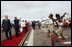 President George W. Bush and President Jakaya Kikwete of Tanzania are joined by Salma Kikwete, spouse of President Jakaya Kikwete, and Mrs Laura Bush as they watch a cultural performance Tuesday, Feb. 19, 2008, at the Julius Nyerere International Airport in Dar es Salaam, Tanzania before their departure to Kigali, Rwanda.