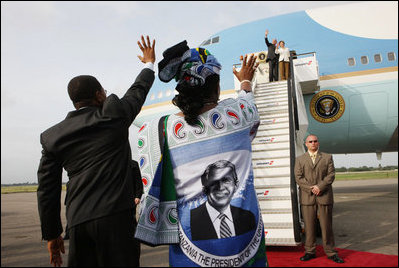 Tanzanian President Jakaya Kikwete and first lady Salma Kikwete, wearing a blouse imprinted with a likeness of President George W. Bush, wave farewell to President Bush and Mrs. Laura Bush Tuesday, Feb. 19, 2008 at Julius Nyerere International Airport in Dar es Salaam, Tanzania.