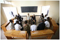 President George W. Bush and Mrs. Laura Bush visit Tuesday, Feb. 19, 2008, with participants who have completed the parent-child communication program, during a meeting at the Lycee de Kigali in Kigali, Rwanda.