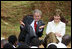 President George W. Bush and Mrs. Laura Bush react during a discussion with members of the Lycee de Kigali 'Anti-AIDS Club' Tuesday, Feb. 19, 2008, outside of the Lycee de Kigali in Kigali, Rwanda.