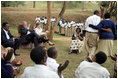 President George W. Bush and Mrs. Laura Bush applaud after a theatrical performance by members of the Lycee de Kigali 'Anti-AIDS Club' Tuesday Feb. 19, 2008, outside of the Lycee de Kigali in Kigali, Rwanda.