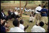 President George W. Bush and Mrs. Laura Bush applaud after a theatrical performance by members of the Lycee de Kigali 'Anti-AIDS Club' Tuesday Feb. 19, 2008, outside of the Lycee de Kigali in Kigali, Rwanda.