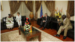 President George W. Bush and Mrs. Laura Bush visit with Ghana President John Agyekum Kufuor and first lady Theresa Kufuor, upon their arrival Tuesday, Feb. 19, 2008, to Kotoka International Airport in Accra, Ghana.