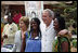 President George W. Bush and Mrs. Laura Bush pose for a photo with two women Wednesday, Feb. 20, 2008, during his visit to the International Trade Fair Center in Accra, Ghana.