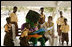 Mrs. Laura Bush participates in a reading lesson with students in their "reading hut" with the school’s reading mascot Wednesday, Feb. 20, 2008, at the Mallam D/A/ Primary School in Accra, Ghana.