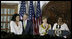 President George W. Bush congratulates singer Jordin Sparks after she sang the U.S. National Anthem Wednesday, Feb. 20, 2008, during the welcome for President Bush and Mrs. Laura Bush to the U.S. Ambassador's Residence in Accra, Ghana, by Ambassador Pamela Bridgewater.