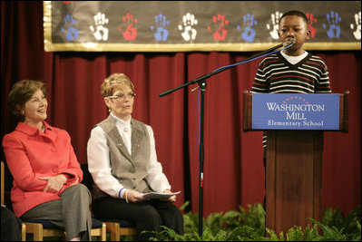 Mrs. Laura Bush and Dr. Tish Howard, Principal, Washington Mill Elementary School, listen as Damien Floyd, Student, reads an essay he wrote on George Washington, during a Mount Vernon's "George Washington's Return to School" ceremony at Washington Mill Elementary School Tuesday, January 15, 2008, in Alexandria, Virginia. The "Portrait of Leadership" initiative was planned to coincide with the 275th birthday year of George Washington, celebrated in February of 2007, to help put a portrait of George Washington in class rooms in all fifty states.