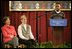 Mrs. Laura Bush and Dr. Tish Howard, Principal, Washington Mill Elementary School, listen as Damien Floyd, Student, reads an essay he wrote on George Washington, during a Mount Vernon's "George Washington's Return to School" ceremony at Washington Mill Elementary School Tuesday, January 15, 2008, in Alexandria, Virginia. The "Portrait of Leadership" initiative was planned to coincide with the 275th birthday year of George Washington, celebrated in February of 2007, to help put a portrait of George Washington in class rooms in all fifty states.