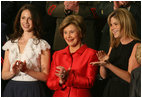 Mrs. Laura Bush, joined by her daughters, Barbara, left, and Jenna applaud from the First Lady's box at the U.S. Capitol, as President George W. Bush delivers his State of the Union Address Monday, Jan. 28, 2008.