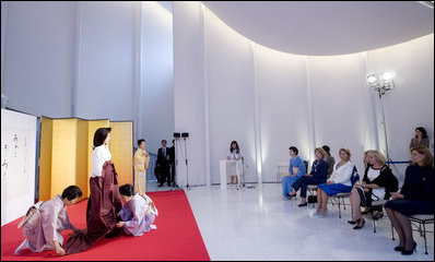 Mrs. Laura Bush joins spouses of G-8 leaders Monday, July 7, 2008, as they participate in a demonstration of a Junihitoe 12-layered Ancient Kimono at the Bridal Chapel and Bridal Salon of the Windsor Hotel Toya Resort and Spa in Toyako, Japan. The event celebrates the 1000th anniversary of the Tale of Genji, a Japanese classic written by Lady Murasaki. Junihitoe means 12 layers, and is an example of the formal court dress worn by women during Murasaki's time.