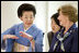 As Mrs. Laura Bush listens, Mrs. Kiyoko Fukuda, spouse of Prime Minister Yasuo Fukuda of Japan, explains the finer details on proper dressing techniques during a demonstration for G-8 spouses of a Junihitoe 12-layered Ancient Kimono Monday, July 7, 2008, at the Windsor Hotel Toya Resort and Spa in Toyako, Japan.