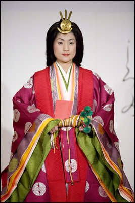 A young woman models a Junihitoe, a 12-layered formal court dress worn by women during the Heian period, during a demonstration of traditional Japanese culture Monday for G-8 spouses at the Windsor Hotel Toya Resort and Spa in Toyako, Japan.