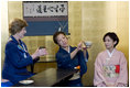 Mrs. Laura Bush receives instruction Monday, July 7, 2008, from Ms. Soko Sakurai on the art of preparing a bowl of tea. Ms. Sakurai is the Tea Master at the Urasenke School, which is active in fostering international goodwill through cultural exchange. Mrs. Bush and spouses of G-8 leaders participated in the tea ceremony during a traditional Japanese cultural program in Toyako, Japan, site of the 2008 G-8 Summit.