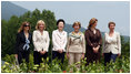 With Mt. Yoteizan as a backdrop, the G-8 Spouses pause Tuesday, July 8, 2008, for their family photo in the village of Makkari on the northern Japanese island of Hokkaido.