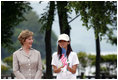 Mrs. Laura Bush stands with Ms. Natsumi Kagawa, age 11, after planting a tree at the Toyako New Mount Showa Memorial Park Wednesday, July 8, 2008, during a tree planting ceremony in Hokkaido, Japan. 