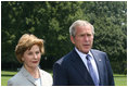 President George W. Bush and Mrs. Laura Bush meet with reporters Sunday, July 13, 2008 upon their arrival back to the White House, to express their sadness on the death of former White House Press Secretary Tony Snow.