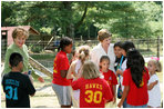 Mrs. Laura Bush, joined by North Carolina Senator Elizabeth Dole, left, greets Junior Ranger participates at a poetry reading event Monday, July 28, 2008, during a tour of the Carl Sandburg Home National Historic Site in Flat Rock, N.C.