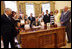 President George W. Bush signs the Caroline Pryce Walker Conquer Childhood Cancer Act of 2008 Tuesday, July 29, 2008, in the Oval Office of the White House. President Bush is joined at his desk by Mrs. Laura Bush, HHS Secretary Mike Leavitt, the Lewis family, the Adams family, the Haight family, the Rech family, and Congressional representatives Sen. Jack Reed D-RI; Minnesota Senator Norm Coleman; Rep. Deborah Pryce R-OH; and Rep. Chris Van Hollen D-MD; and CureSearch's Dr. Gregory Reaman. 