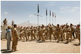 Mrs. Laura Bush is greeted Sunday, June 8, 2008, by New Zealand troops performing a traditional warrior dance at the Bamiyan Provincial Reconstruction Team Base in Afghanistan's Bamiyan province. Standing with her is Major Justin de la Haye.