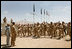 Mrs. Laura Bush is greeted Sunday, June 8, 2008, by New Zealand troops performing a traditional warrior dance at the Bamiyan Provincial Reconstruction Team Base in Afghanistan's Bamiyan province. Standing with her is Major Justin de la Haye.