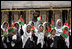 Future students of the Ayenda Learning Center wave flags and greet Mrs. Laura Bush during her visit to the construction site of the Ayenda Learning Center Sunday, June 8, 2008, in Bamiyan, Afghanistan.