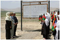 Mrs. Laura Bush is greeted by future students of the Ayenda Learning Center during her visit to the school's construction site Sunday, June 8, 2008, in Bamiyan, Afghanistan. Joining Mrs. Bush is Governor of Bamiyan Province Habiba Sarabi, left, and Ihsan Ullah Bayat, who directed a tour of the site. 