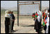 Mrs. Laura Bush is greeted by future students of the Ayenda Learning Center during her visit to the school's construction site Sunday, June 8, 2008, in Bamiyan, Afghanistan. Joining Mrs. Bush is Governor of Bamiyan Province Habiba Sarabi, left, and Ihsan Ullah Bayat, who directed a tour of the site. 