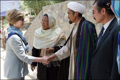 Mrs. Laura Bush meets with local leaders as she arrives June 9, 2008 at the Bamiyan Bazaar in Afghanistan to inaugurate work on the road project.