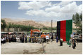 Mrs. Laura Bush, to the right of the podium, is introduced June 9, 2008 by the Bamiyan major as workmen prepare to break ground for the Bamiyan Bazaar road project in Afghanistan.