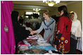 Mrs. Laura Bush greets local businesswomen as she tours the marketplace of the Arzu and Bamiyan Women's Business Association on June 9, 2008 in Afghanistan. The carpets, embroidery and other Afghan wares are all made by women.