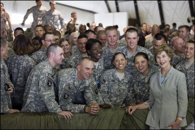 Mrs. Laura Bush poses for a photo with US troops during her visit to Bagram Air Force Base Sunday, June 8, 2008, in Bagram, Afghanistan.