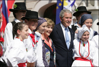 President George W. Bush and Laura Bush pose for a photo with children dressed in traditional outfits during their visit Tuesday, June 10, 2008, to the Lipizzaner Horse Exhibition at Brdo Castle in Kranj, Slovenia.