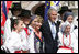 President George W. Bush and Laura Bush pose for a photo with children dressed in traditional outfits during their visit Tuesday, June 10, 2008, to the Lipizzaner Horse Exhibition at Brdo Castle in Kranj, Slovenia.