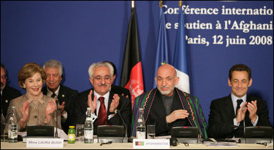 Mrs. Laura Bush joins in the applause during the U.S.-Afghan Donor's Conference Thursday, June 12, 2008 in Paris, where Mrs. Bush addressed the conference urging continued support for the Afghanistan people to build civic and economic institutions that can withstand the forces of oppression. Mrs. Bush is joined on the panel, from left, Afghanistan Foreign Minister Dr. Rangin Dadfar Spanta, Afghanistan President Hamid Karzai and French President Nicholas Sarkozy.