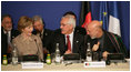 Mrs. Laura Bush, seated next to Afghanistan Foreign Minister Dr. Rangin Dadfar Spanta, speaks with Afghanistan President Hamid Karzai, right, during the U.S.-Afghan Donor's Conference Thursday, June 12, 2008, in Paris.