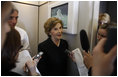 Mrs. Laura Bush speaks with members of the press June 13, 2008 aboard Air Force One, as she and President Bush travel from Rome to Paris on their multi-city European visit.