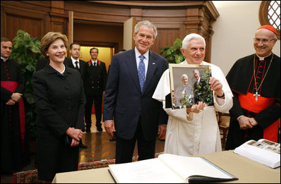 President George W. Bush and Laura Bush present Pope Benedict XVI with a framed photograph Friday, June 13, 2008, during their visit to the Vatican, The photo shows President Bush and Pope Benedict XVI together at the White House during the Pope's visit in April.