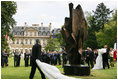 President George W. Bush and Laura Bush, accompanied by French President Nicolas Sarkozy, attend the unveiling of the Flamme de la Liberté sculpture Saturday, June 14, 2008, at the U.S. Ambassador's residence in Paris.