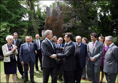 President George W. Bush and French President Nicolas Sarkozy shake hands following the unveiling of the Flamme de la Liberté sculpture Saturday, June 14, 2008, at the U.S. Ambassador's residence in Paris.