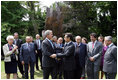 President George W. Bush and French President Nicolas Sarkozy shake hands following the unveiling of the Flamme de la Liberté sculpture Saturday, June 14, 2008, at the U.S. Ambassador's residence in Paris.