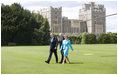 President George W. Bush and Laura Bush wave upon their arrival to Windsor Castle Sunday, June 15, 2008 in Windsor, England, escorted by Air Vice Marshal David Walker, where President Bush and Mrs. Bush met with Queen Elizabeth II and the Duke of Edinburgh Prince Phillip.